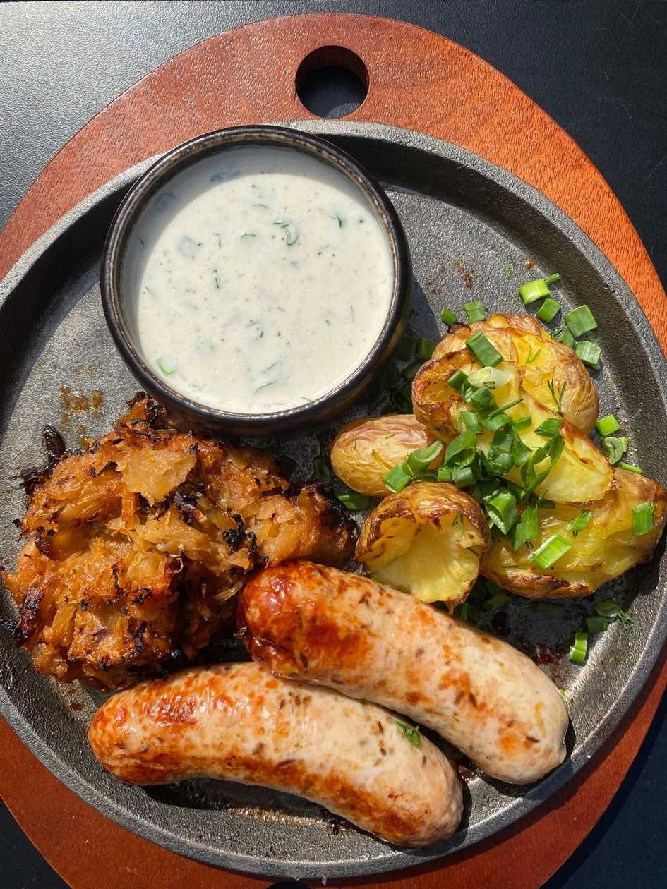 Homemade cups with boiled potatoes and stewed cabbage with creamy-horseradish sauce