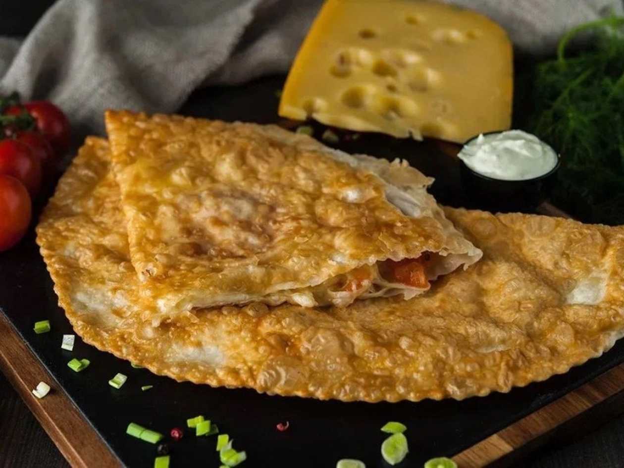 Cheburek with 4 cheeses and tomatoes