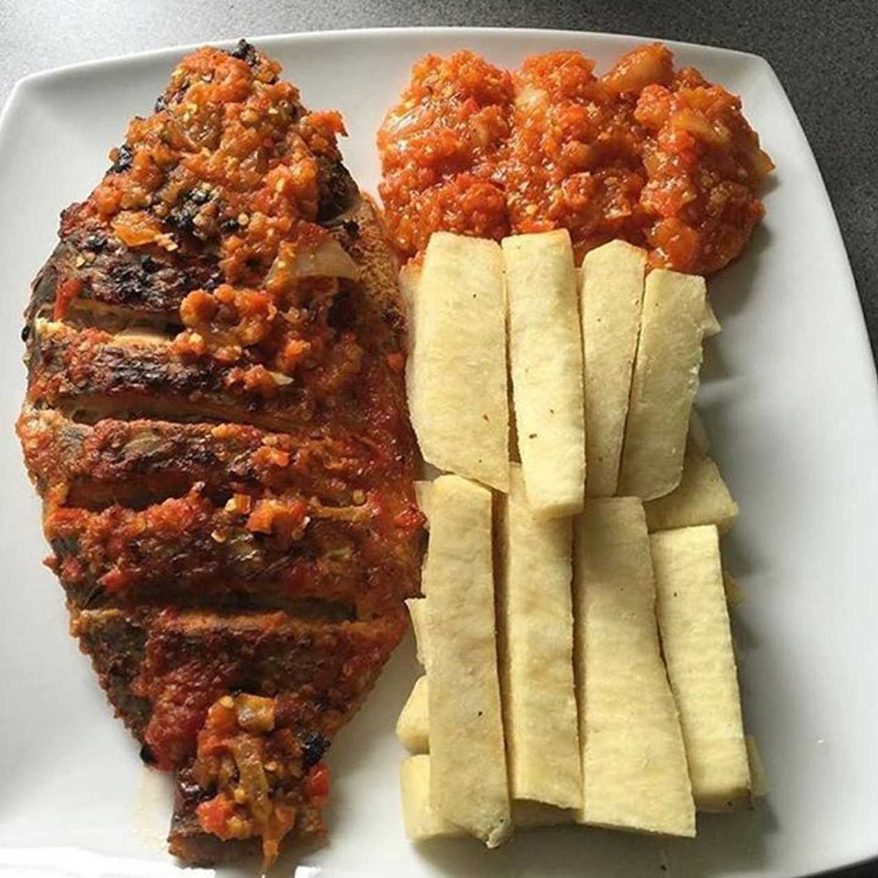 Fried yam with Fried eggs, grilled tilapia grilled sausage and Fried gizzard