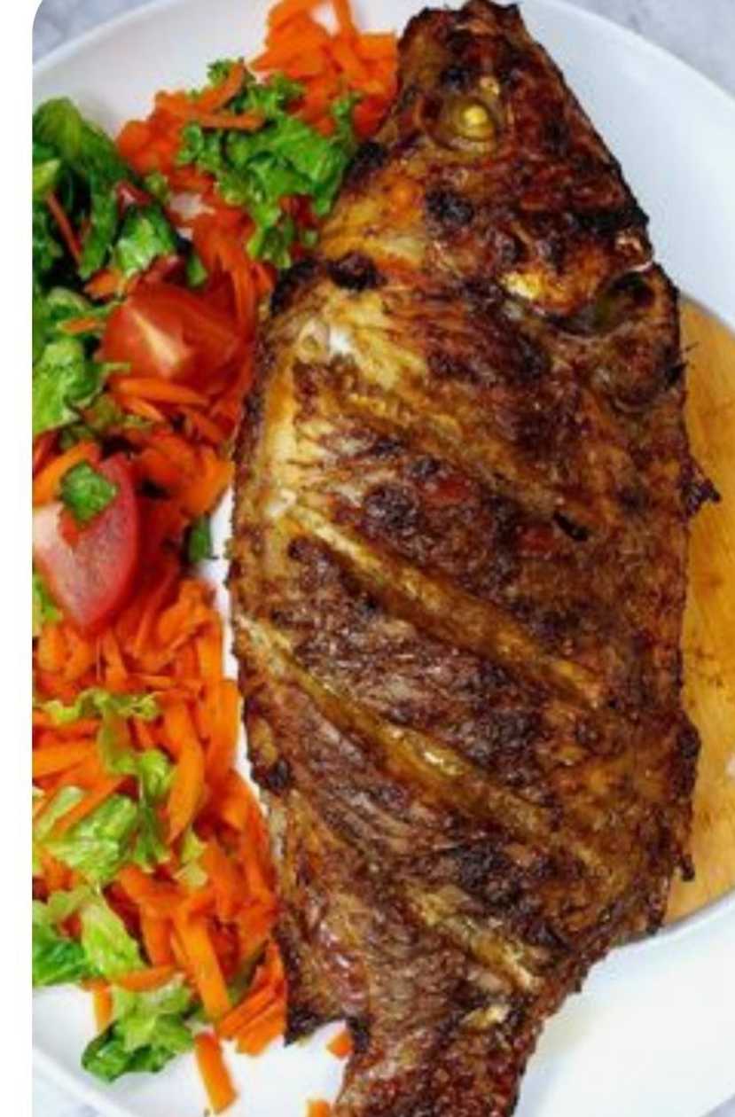 Grilled tilapia served with chilli pepper and vegetable (full big tilapia)