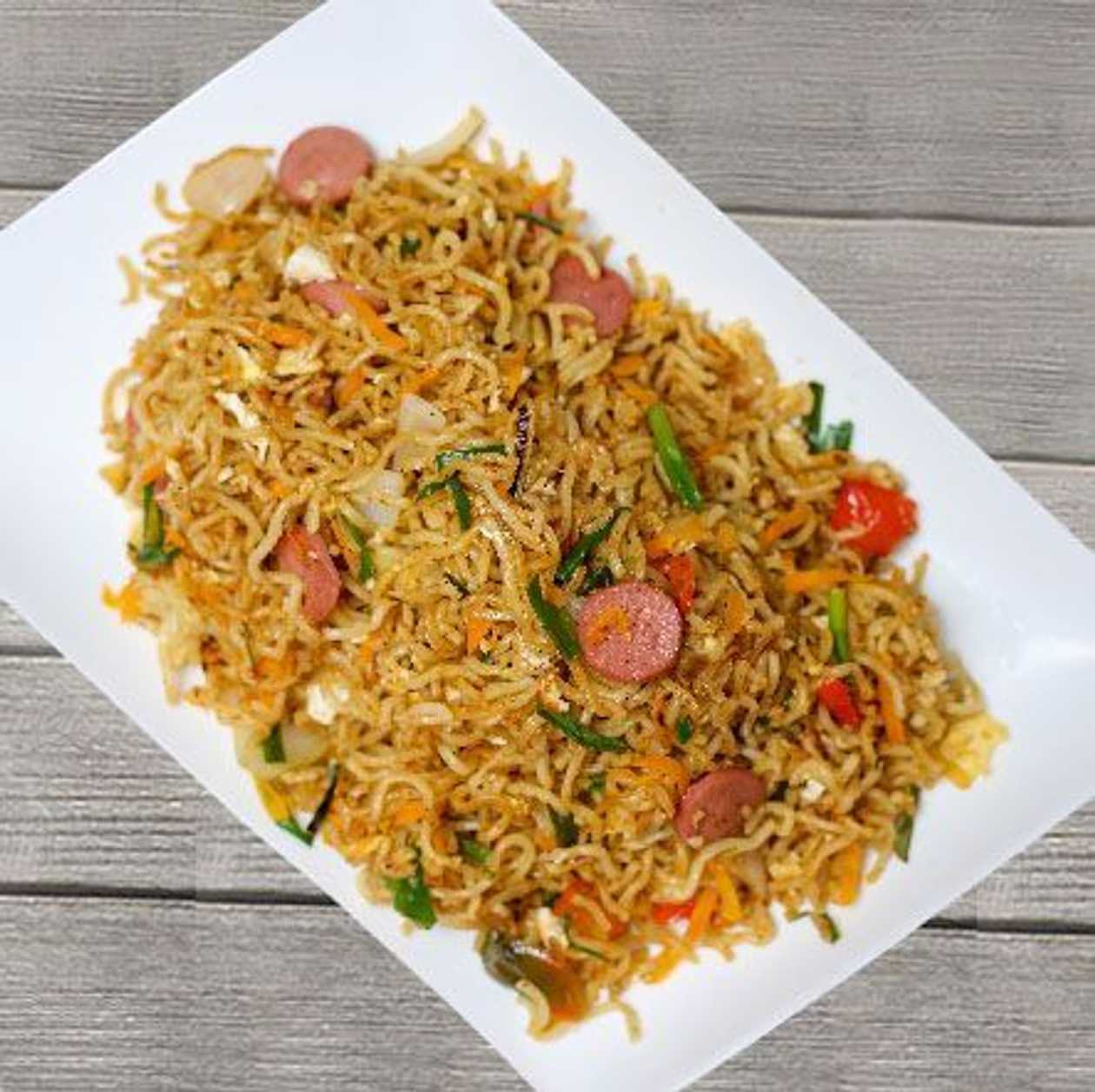 Indomie with sausage gizzard egg sardine conned beef veggies