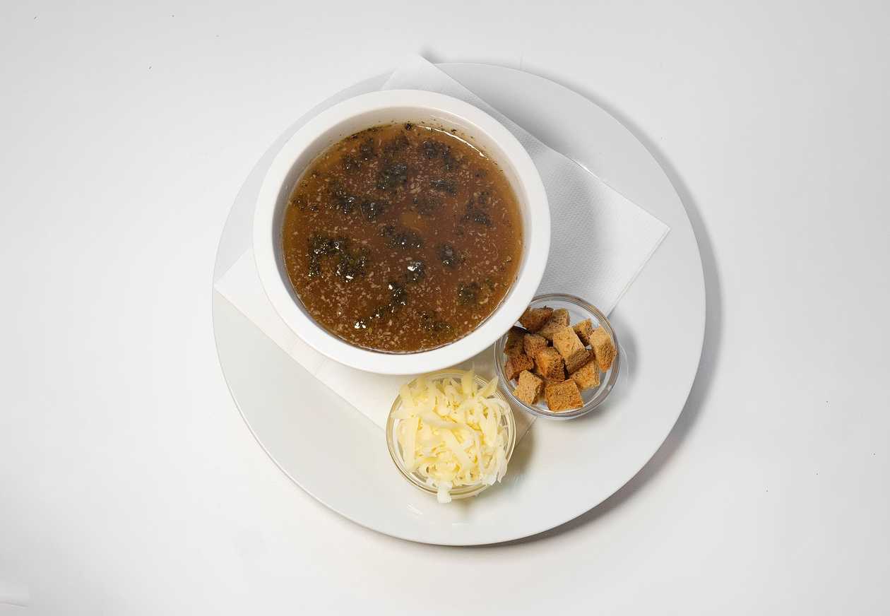 Delicate garlic soup with smoked meat, cheese and croutons