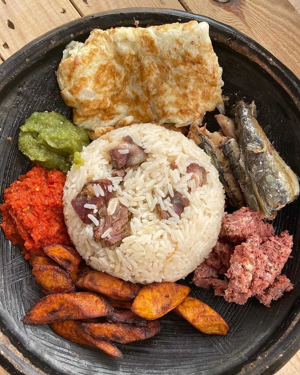 Angwamo with Grilled Tilapia, Fried Eggs, Fried Gizzard, and Grilled Sausage, Served with Vegetables