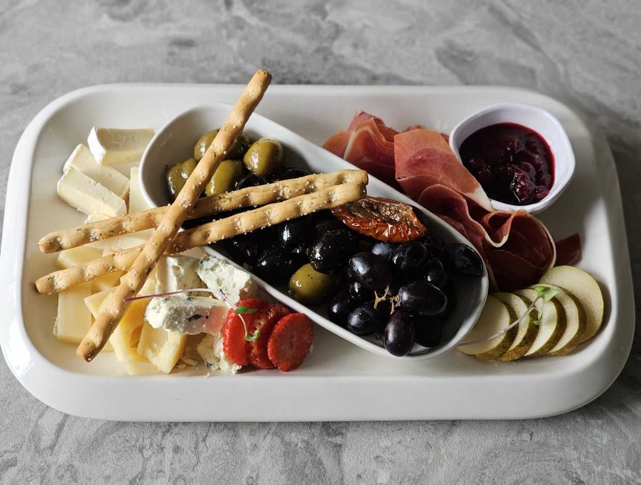 A set of cheeses and olives