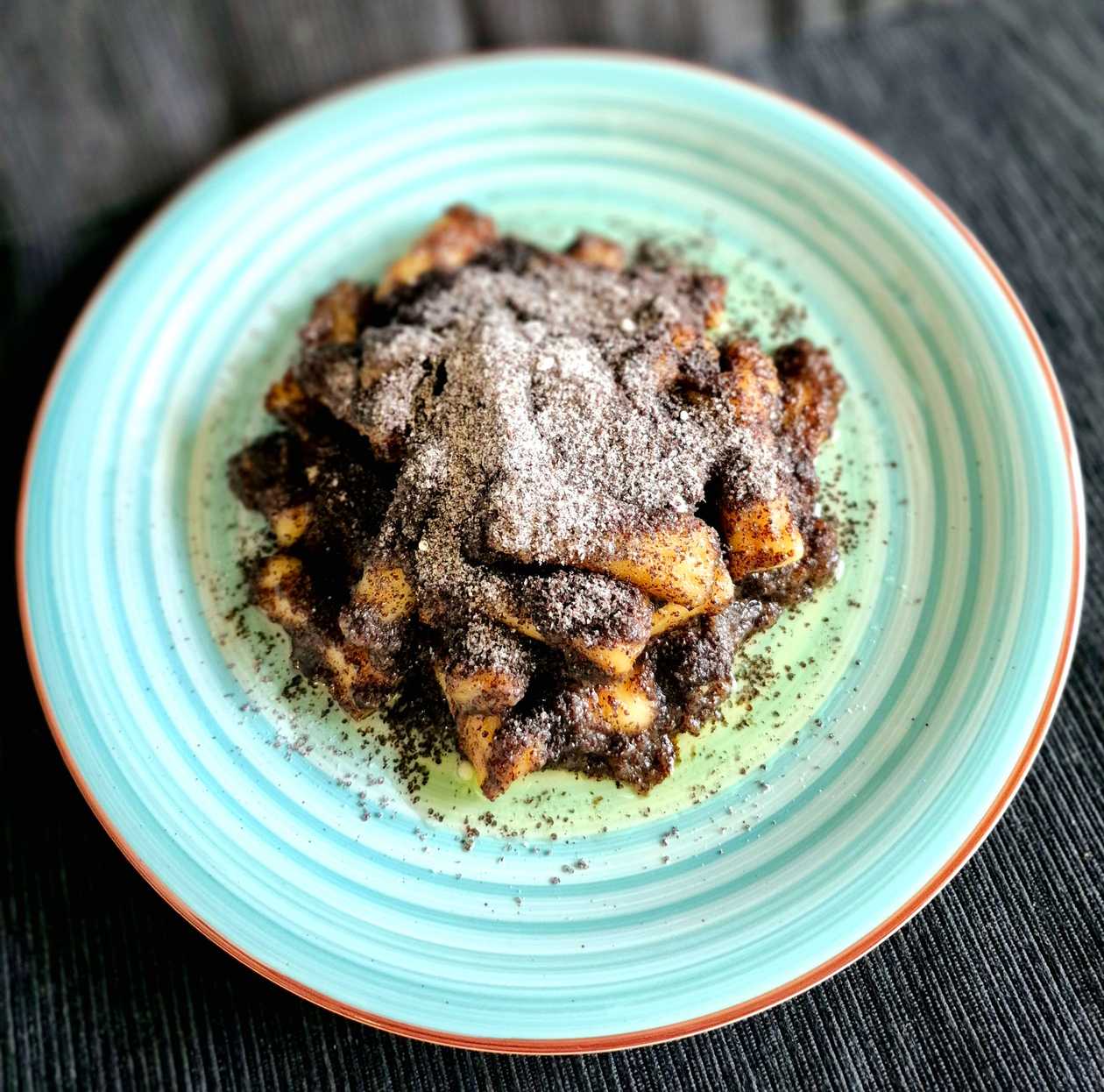 Potato dumplings with poppy seeds, plum jam, and butter