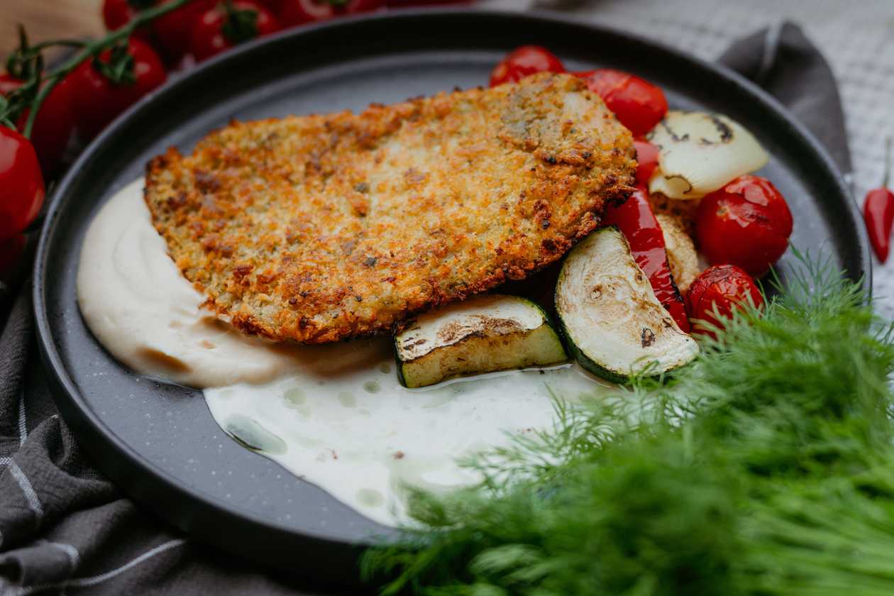 Chicken schnitzel with celeriac cream and roasted carrots