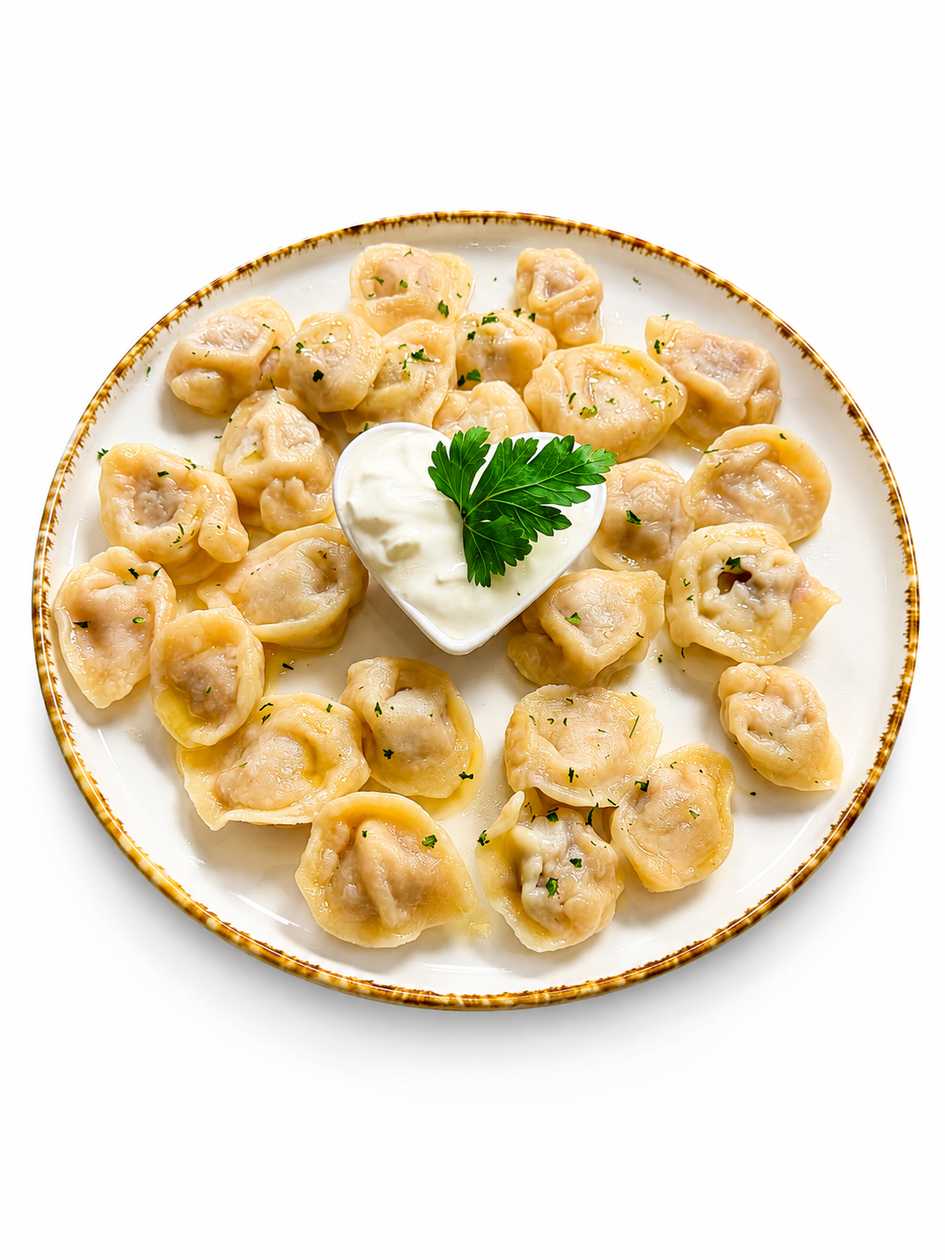 Homemade meat-filled pelmeni served with sour cream