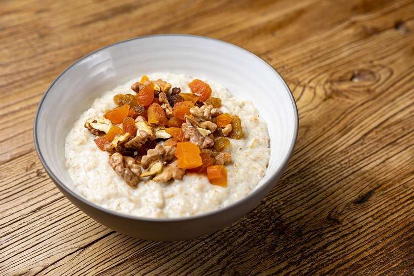 Oatmeal with dried fruits and nuts cooked in milk