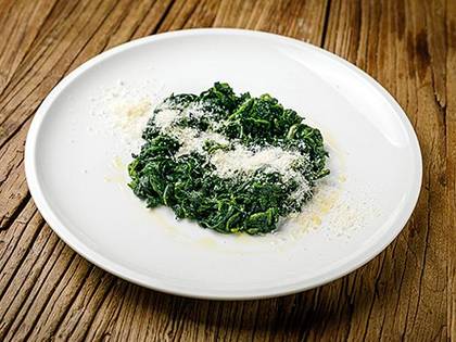 Stewed spinach with garlic butter served with Parmesan cheese
