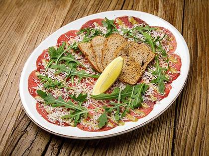 Veal carpaccio with Pecorino, Porto sauce and arugula