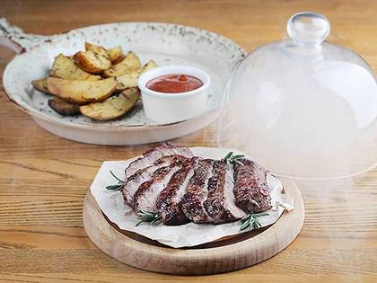 Pork steak with baked potatoes and herbs