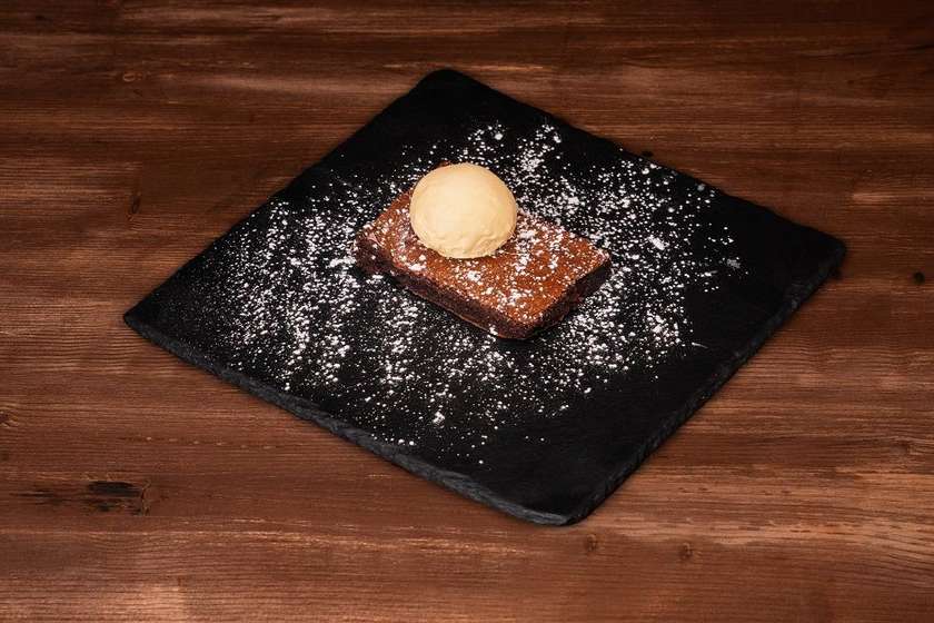 Chocolate brownie with cherries and ice cream