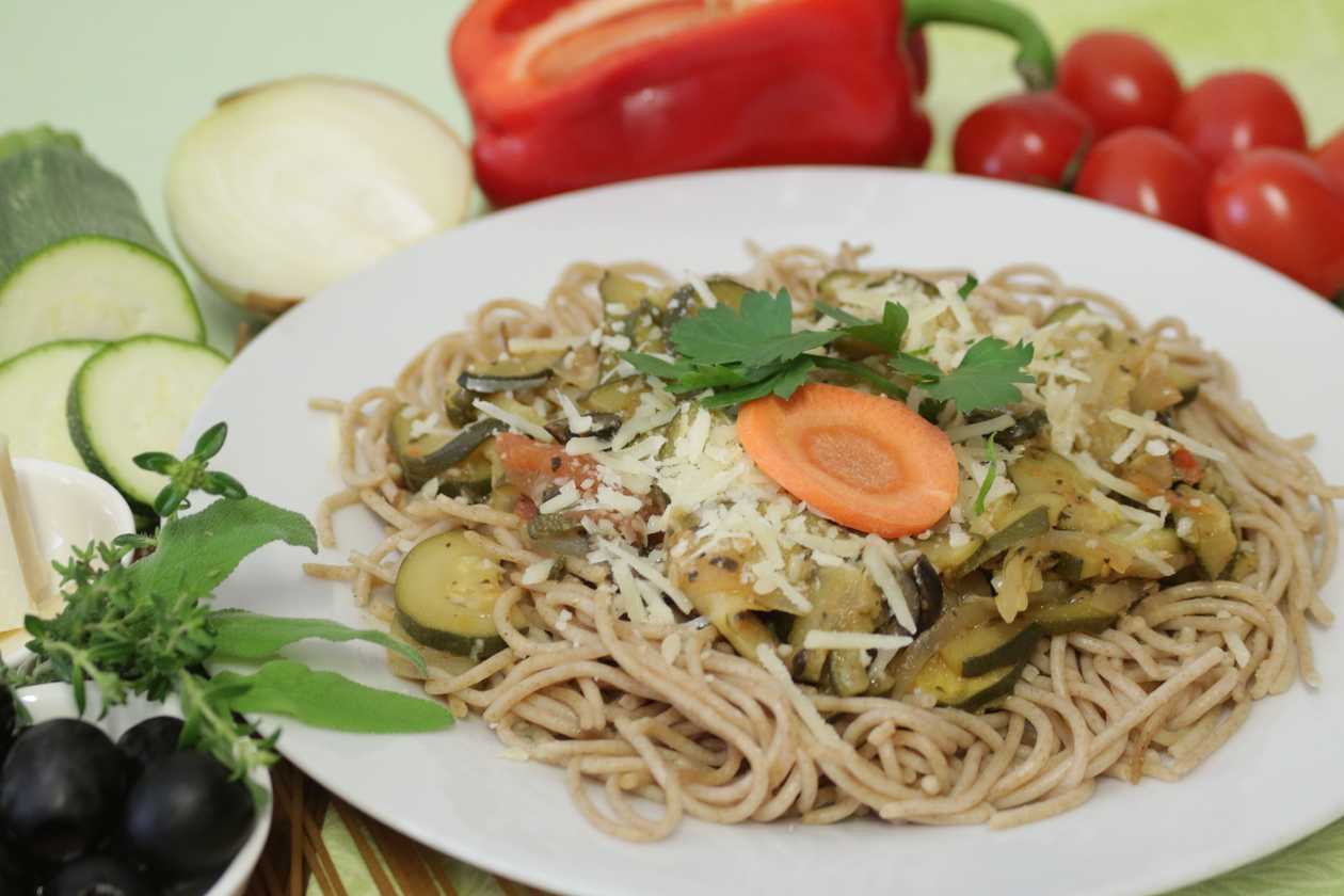 Graham spaghetti with zucchini mix with olives, parmesan