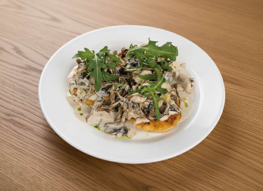 Polenta with a mix of mushrooms in creamy sauce