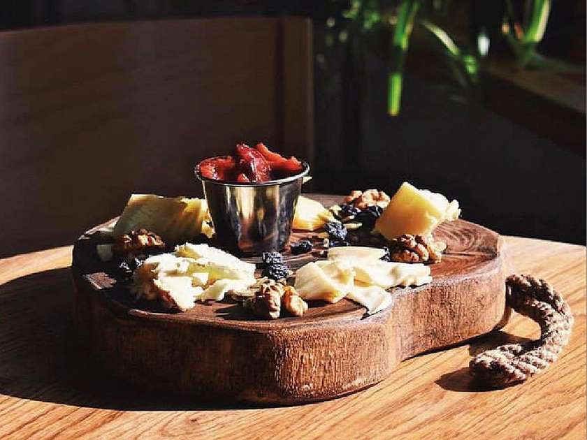 Board of farm cheeses with sharp honey
