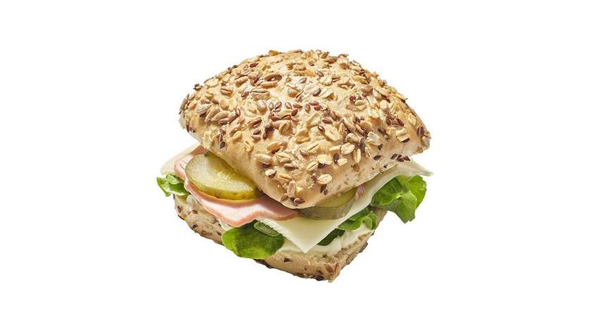 Muesli sandwich with ham, cheese, and pickled cucumber