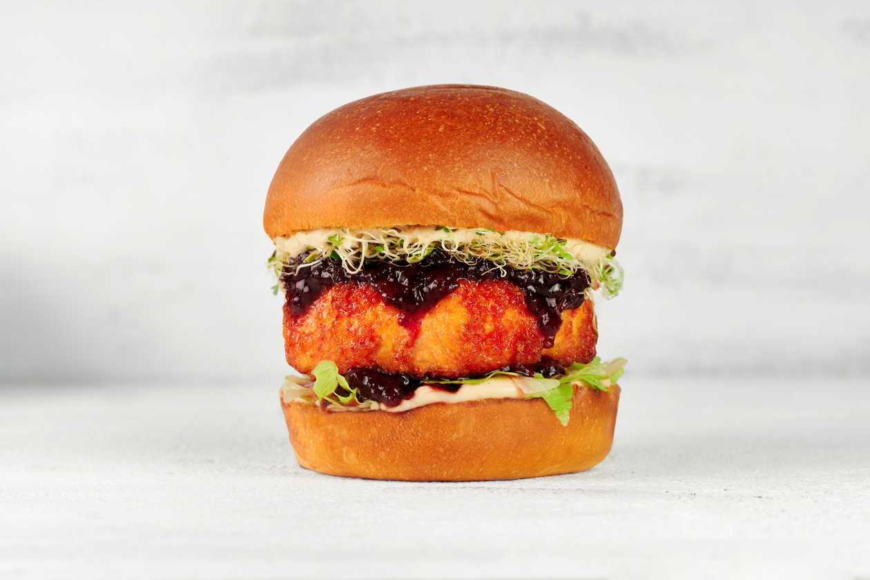 Vegetarian Kamado Club burger with grill camembert cheese and lingonberries