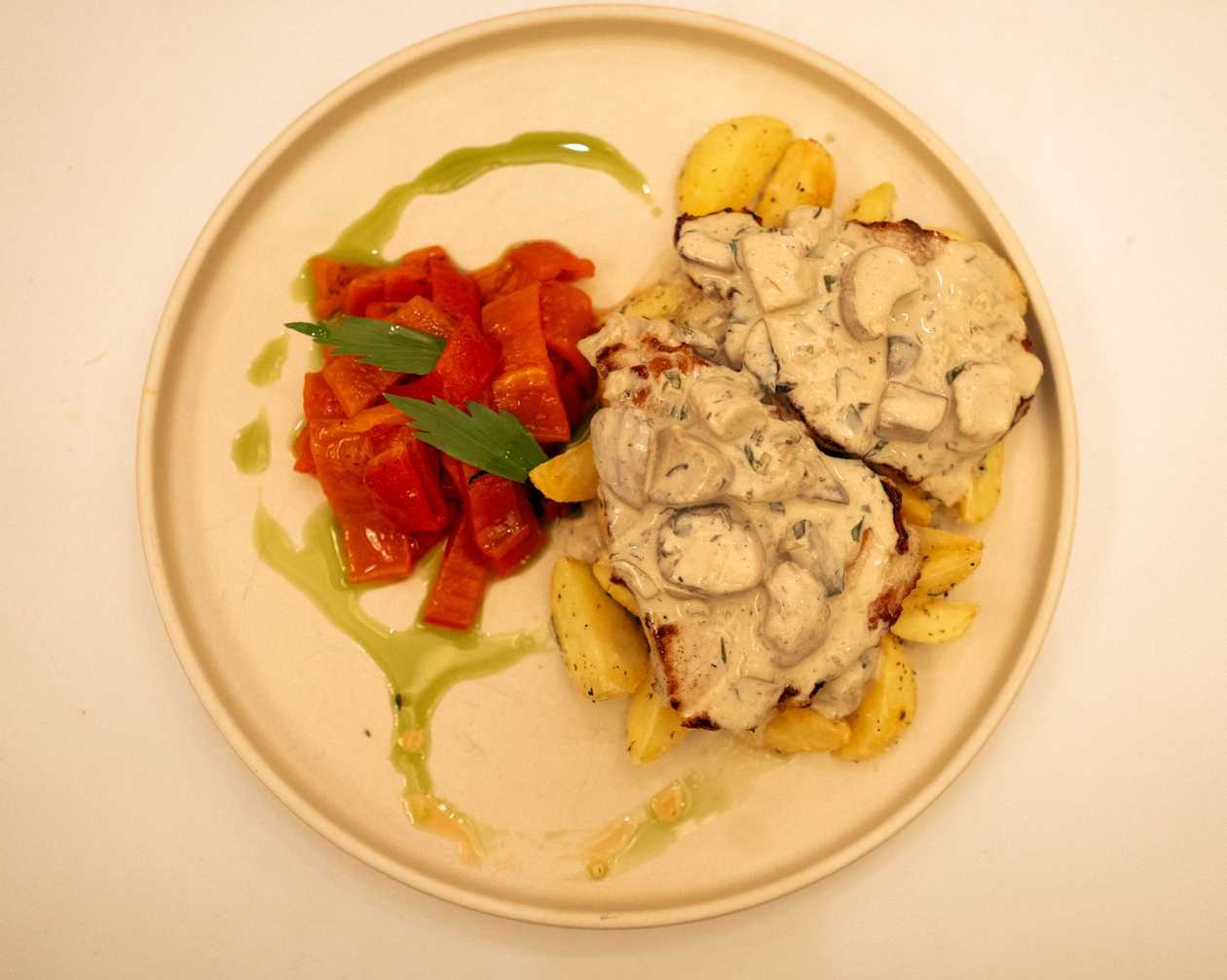 Pork Chop with Potato Wedges, Mushroom Sauce, and Roasted Peppers